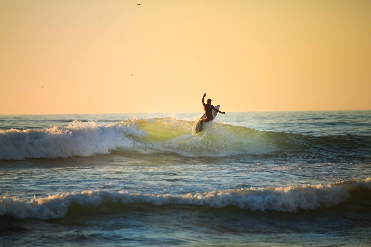 Surfer riding a massive barrel wave near Taghazout