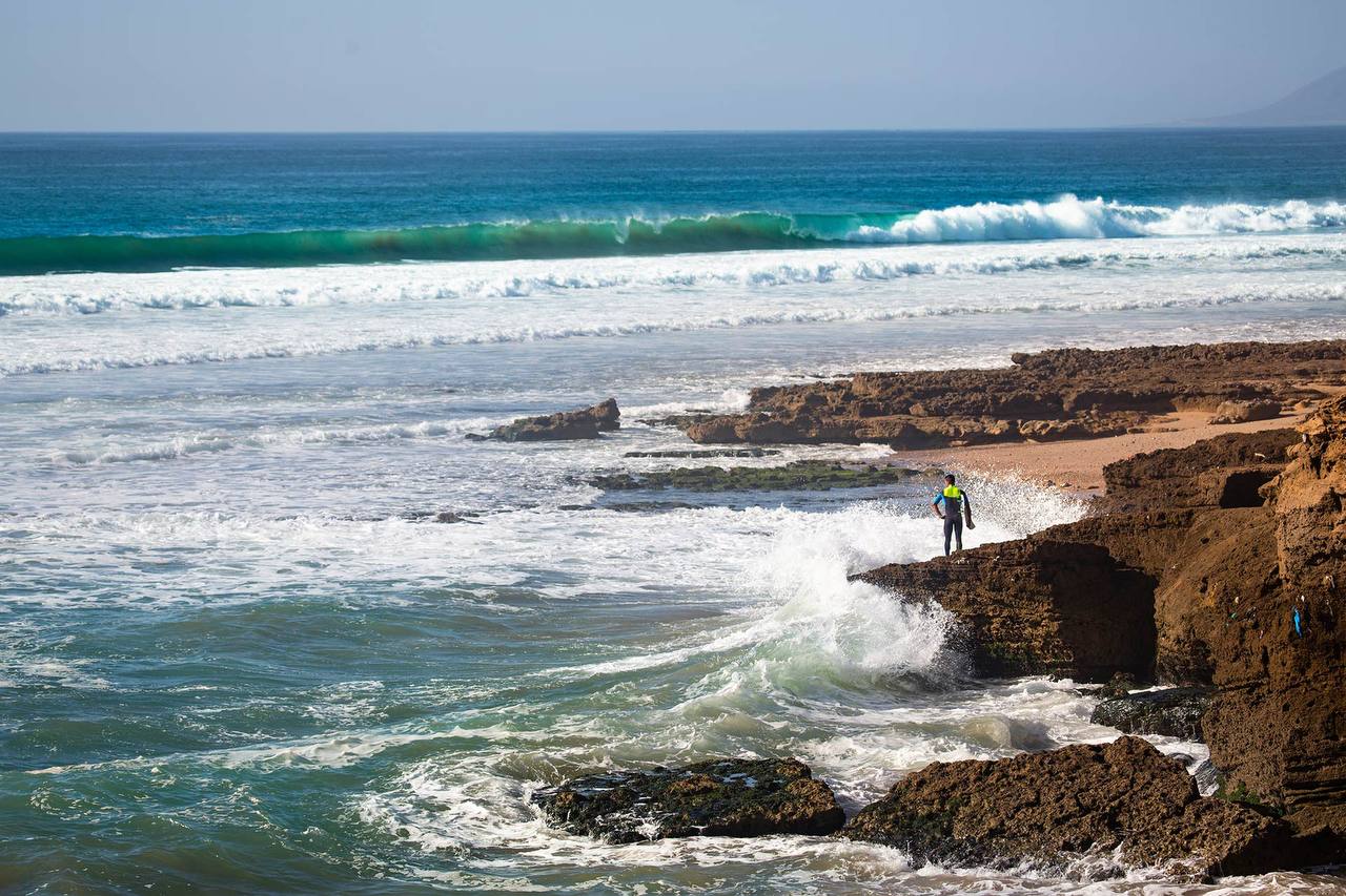 Surfer on a small wave during golden hour in Morocco