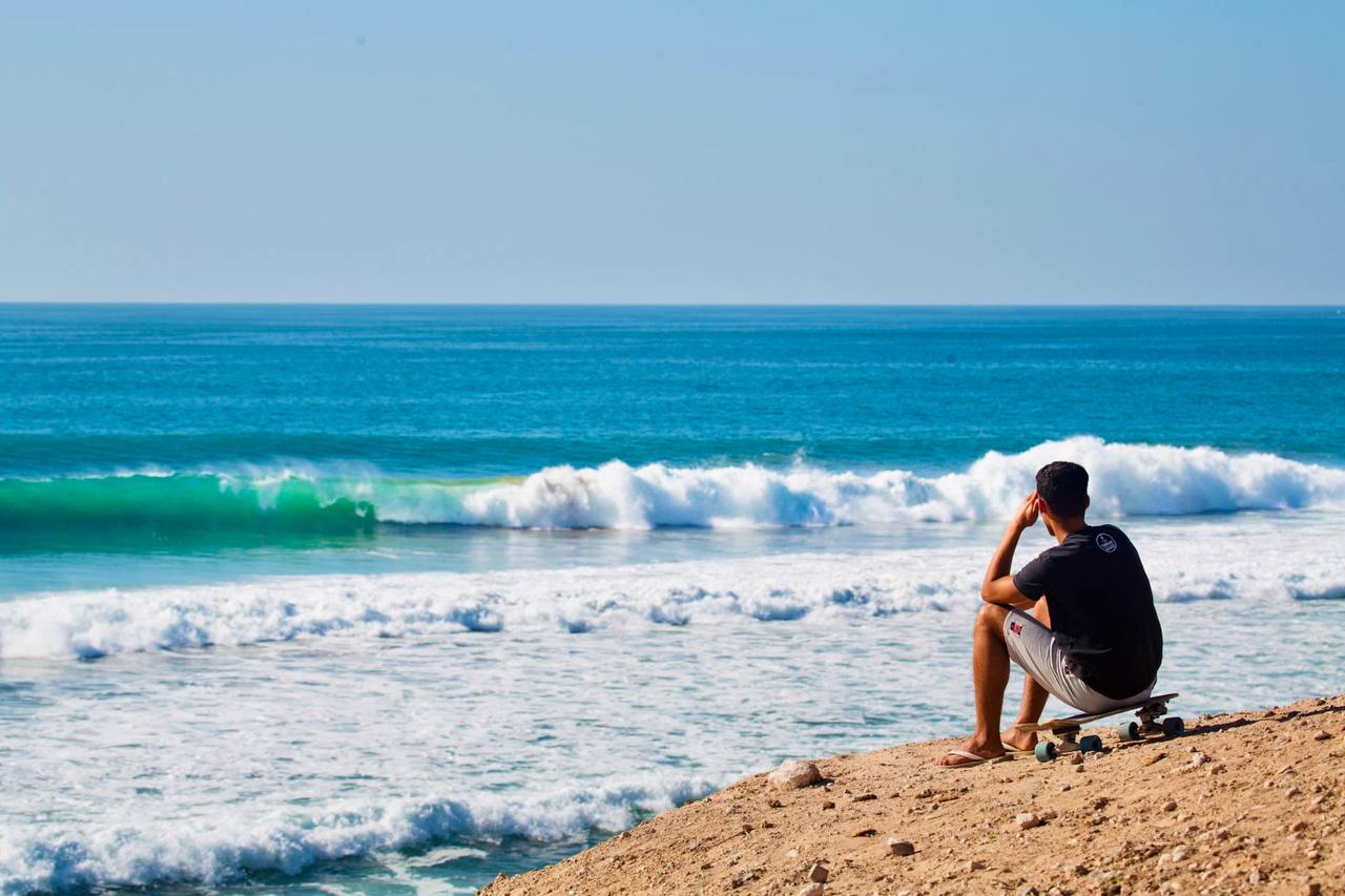 Surfer gliding across Banana Beach in Aourir