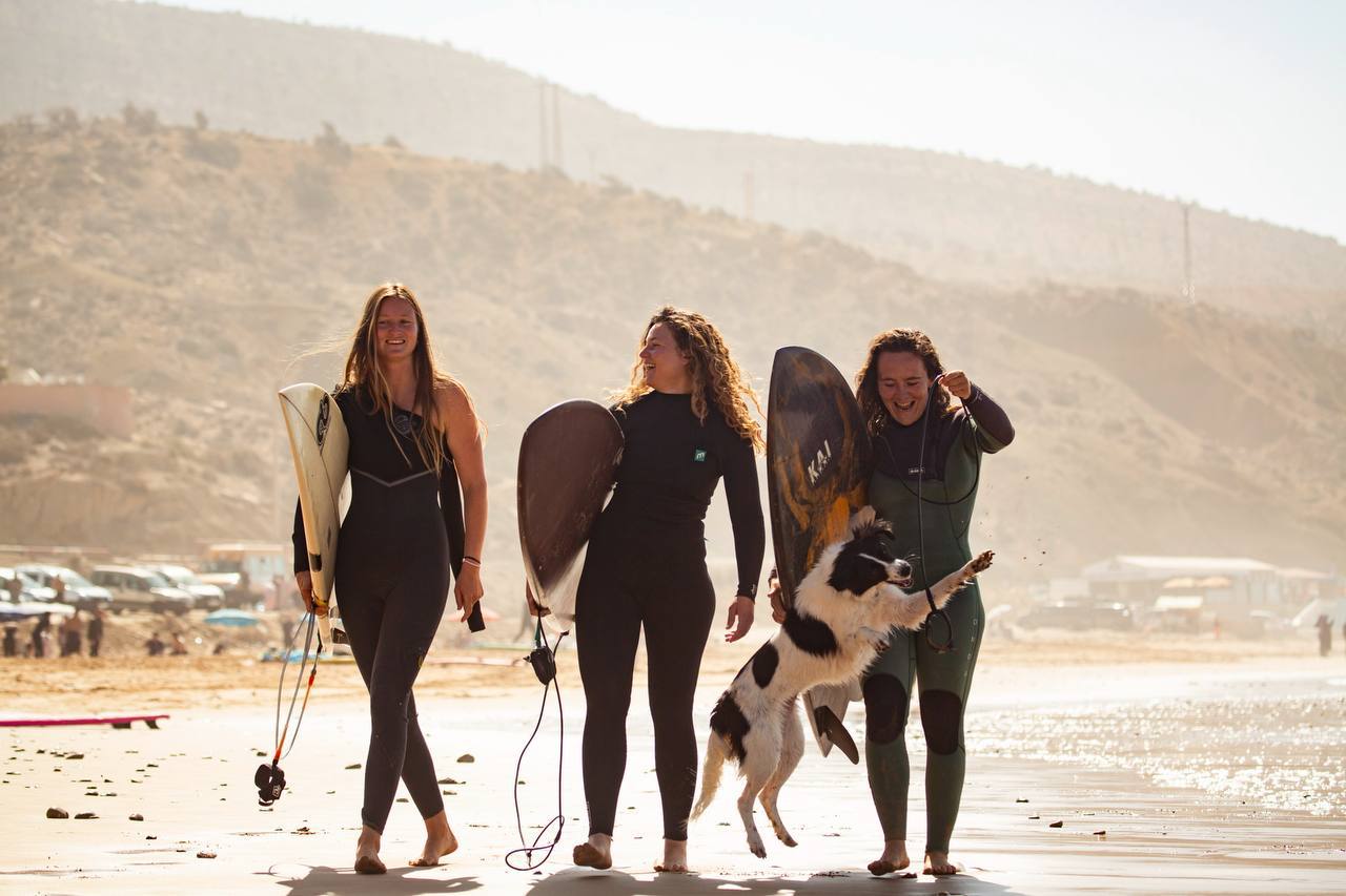 Friends laughing after a session at Camel Beach in Imi Ouaddar